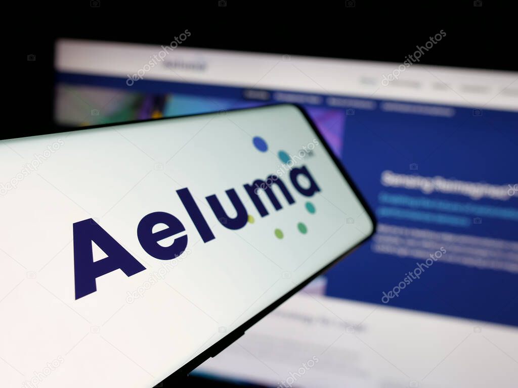 Stuttgart, Germany - 06-07-2025: Smartphone with logo of US semiconductor company Aeluma Inc. on screen in front of website. Focus on left of phone display.