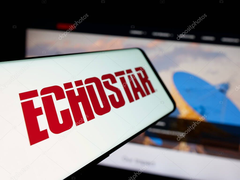 Stuttgart, Germany - 06-07-2025: Smartphone with logo of US telecom company EchoStar Corporation on screen in front of website. Focus on center-left of phone display.
