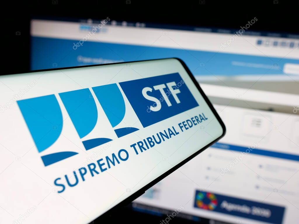 Stuttgart, Germany - 06-09-2025: Smartphone with logo of Brazil court Supremo Tribunal Federal (STF) on screen in front of website. Focus on center of phone display.