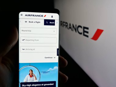 Stuttgart, Almanya - 06-11-2025: Havayolu şirketi Societe Air France S.A. 'nın internet sayfası ile cep telefonu tutan kişi logonun önünde ekranda. Telefon ekranının merkezine odaklan.