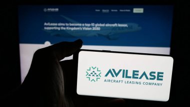 Stuttgart, Almanya - 06-13-2025: Suudi uçak kiralama şirketi AviLease 'in logosunun bulunduğu cep telefonu web sayfasının önünde duruyor. Telefon ekranına odaklan.
