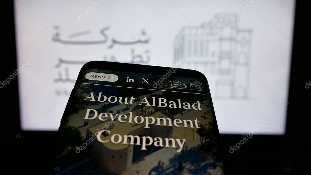 Stuttgart, Germany - 06-14-2025: Mobile phone with website of business Al Balad Development Company (BDC) on screen in front of logo. Focus on top-left of phone display.