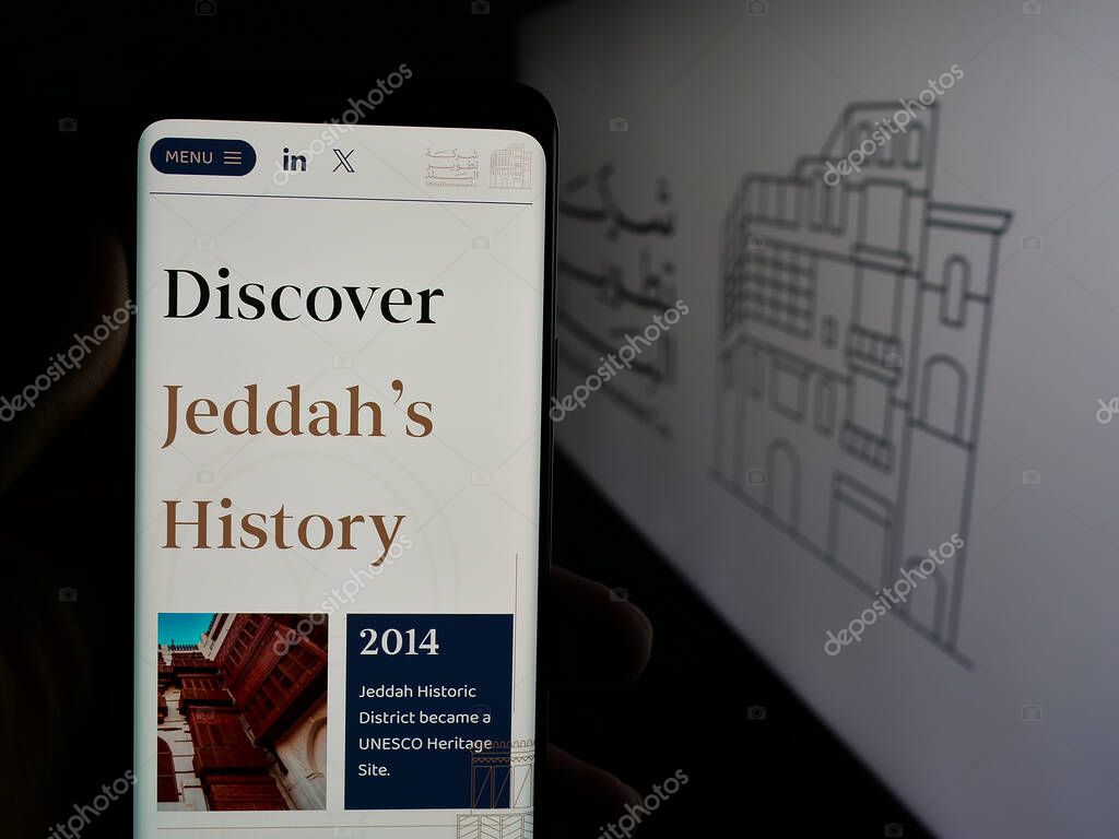 Stuttgart, Germany - 06-14-2025: Person holding smartphone with web page of business Al Balad Development Company (BDC) on screen in front of logo. Focus on center of phone display.