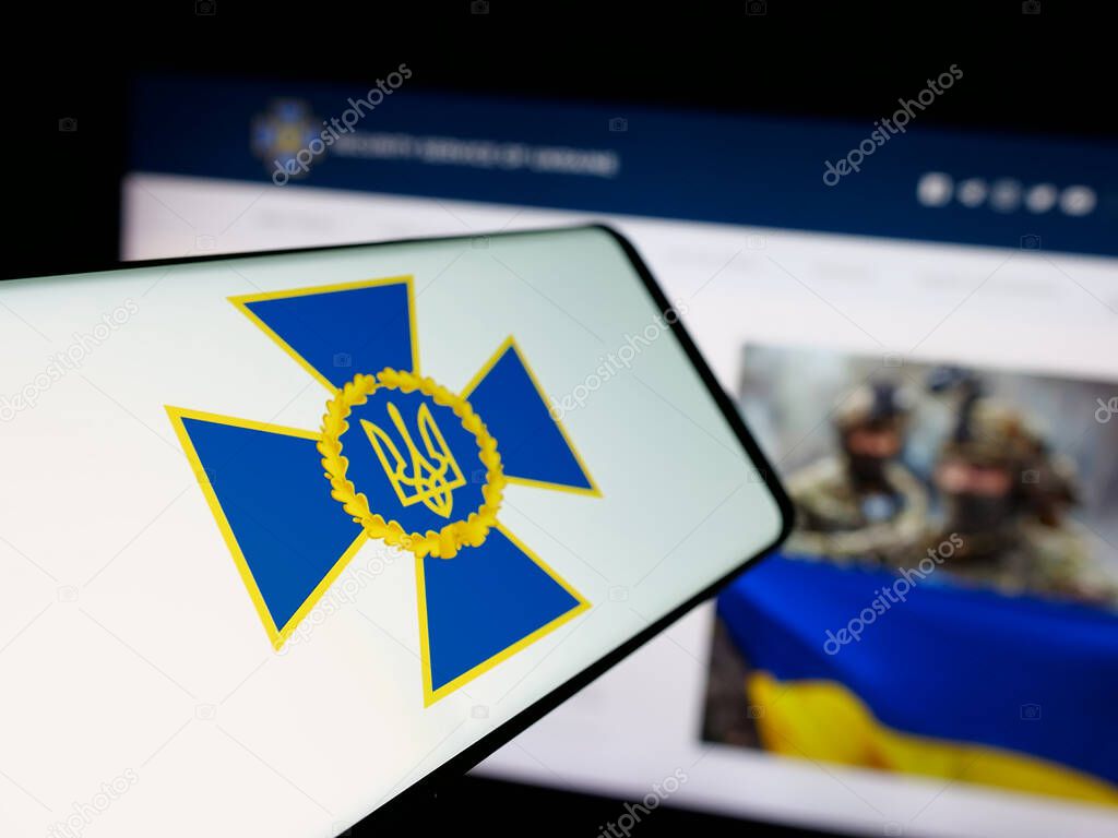 Stuttgart, Germany - 06-18-2025: Smartphone with logo of security service Sluzhba Bezpeky Ukrainy SBU on screen in front of website. Focus on center-left of phone display.
