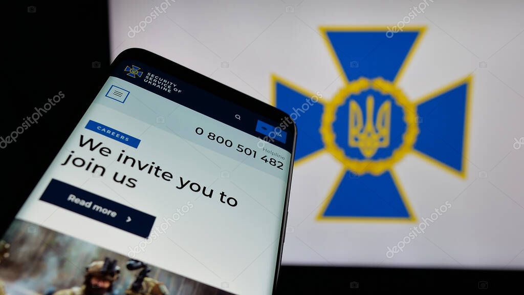 Stuttgart, Germany - 06-18-2025: Mobile phone with website of security service Sluzhba Bezpeky Ukrainy SBU on screen in front of logo. Focus on top-left of phone display.