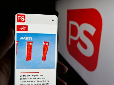 Stuttgart, Almanya - 07-10-2025: Belçika 'nın siyasi partisi Parti Socialiste' nin (PS) web sayfası logo önünde bulunan kişi. Telefon ekranının merkezine odaklan.