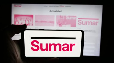 Stuttgart, Almanya - 07-18-2025: İspanyol siyasi partisi Movimiento Sumar 'ın logosunun bulunduğu cep telefonu web sayfası önünde ekranda. Telefon ekranına odaklan.
