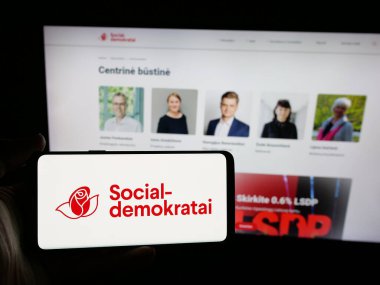 Stuttgart, Almanya - 07-28-2025: İnternet sitesi önünde Lietuvos Socialdemokratu Partija (LSDP) partisinin logosuna sahip akıllı telefon sahibi kişi görülüyor. Telefon ekranına odaklan.