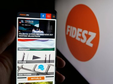 Stuttgart, Almanya - 08-01-2025: Parti Fidesz - Magyar Polgari Szovetseg 'in web sayfası logonun önünde duran kişi. Telefon ekranının merkezine odaklan.