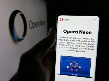 Stuttgart, Almanya - 08-14-2025: Logo önündeki ekranda Norveçli tarayıcı yazılım şirketi Opera Neon 'un web sayfası ile cep telefonu tutan kişi. Telefon ekranının merkezine odaklan.
