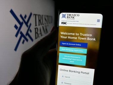 Stuttgart, Almanya - 08-18-2025: ABD 'li finans hizmetleri şirketi Trustco Bank' ın web sayfası olan cep telefonu logosu önünde ekranda. Telefon ekranının merkezine odaklan.