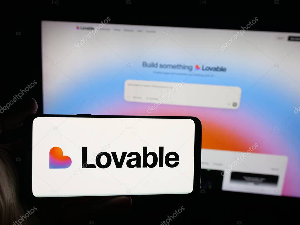 Stuttgart, Germany - 09-25-2025: Person holding smartphone with logo of Swedish ai software company Lovable Labs Inc. on screen in front of website. Focus on phone display.