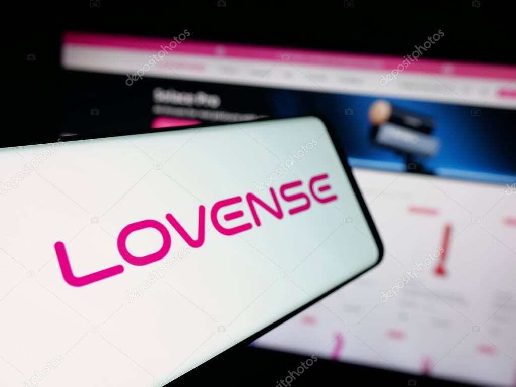 Stuttgart, Germany - 09-25-2025: Smartphone with logo of sex toy company Lovense (Hytto Pte. Ltd.) on screen in front of website. Focus on left of phone display.