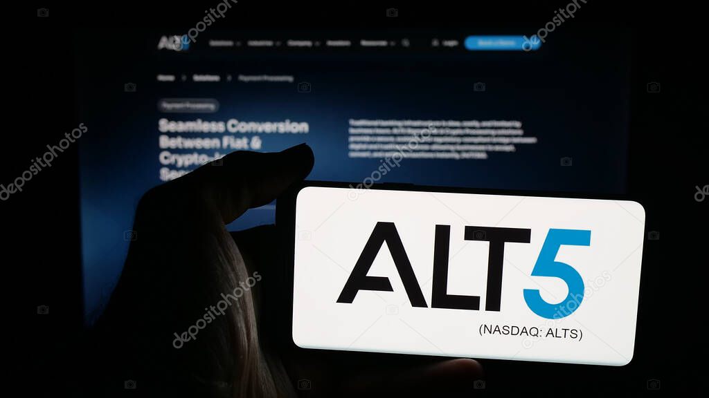 Stuttgart, Germany - 09-27-2025: Person holding mobile phone with logo of US financial company ALT5 Sigma Corporation on screen in front of web page. Focus on phone display.