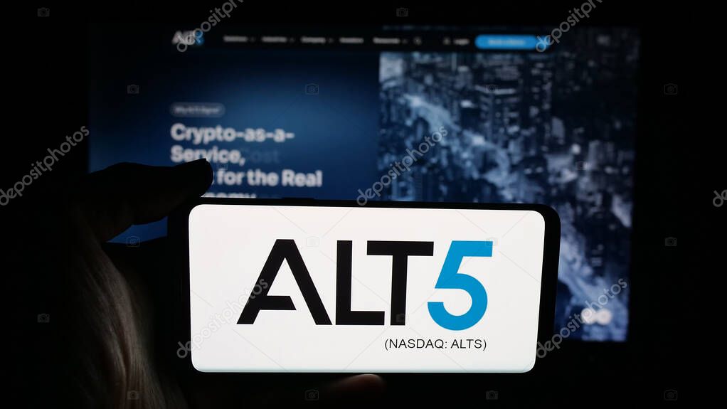 Stuttgart, Germany - 09-27-2025: Person holding cellphone with logo of US financial company ALT5 Sigma Corporation on screen in front of webpage. Focus on phone display.