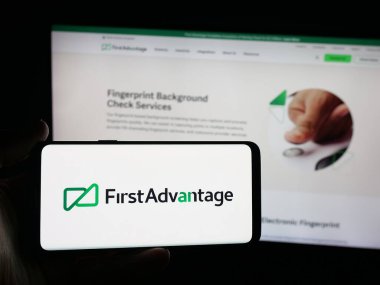 Stuttgart, Almanya - 09-27-2025: ABD geçmiş kontrol şirketinin logosuna sahip akıllı telefon sahibi kişi web sitesinin önünde ekranda. Telefon ekranına odaklan.