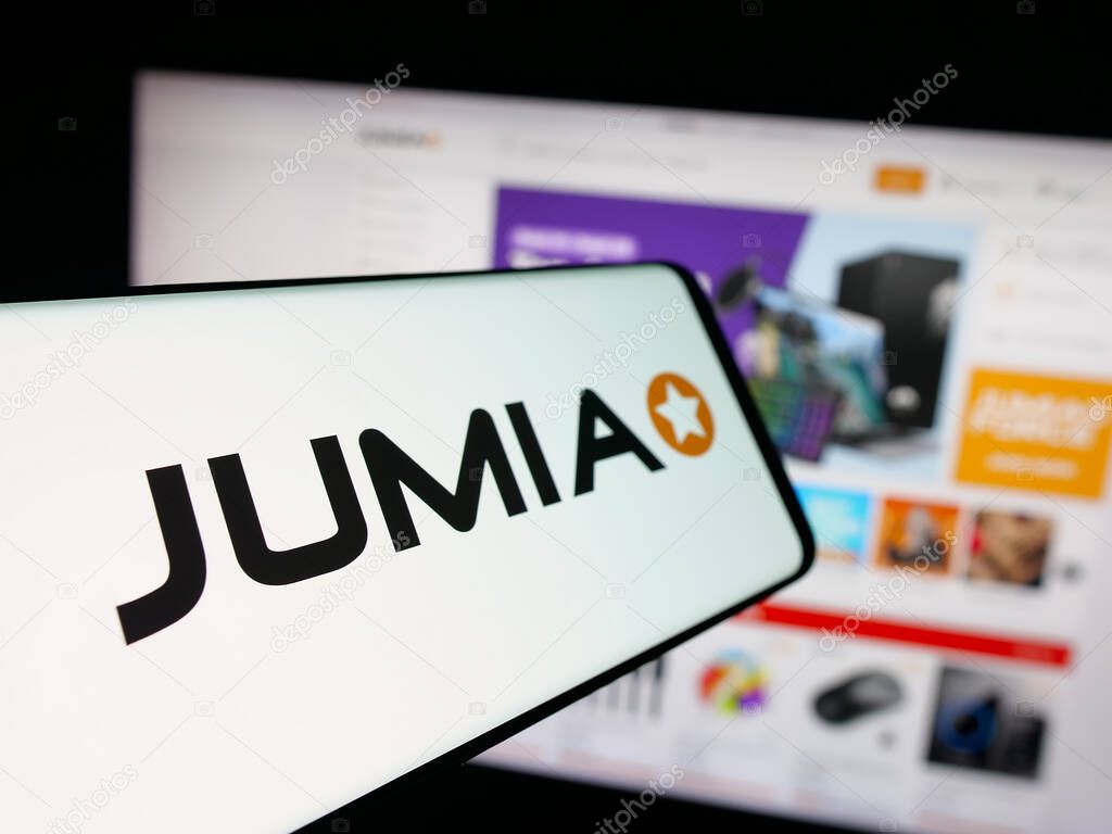 Stuttgart, Germany - 09-29-2025: Smartphone with logo of e-commerce company Jumia Technologies AG on screen in front of website. Focus on center-left of phone display.