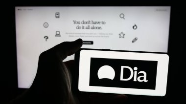 Stuttgart, Almanya - 10-04-2025: Web sayfasının önünde ekranda yapay zeka logosuna (AI) sahip cep telefonu sahibi kişi. Telefon ekranına odaklan.