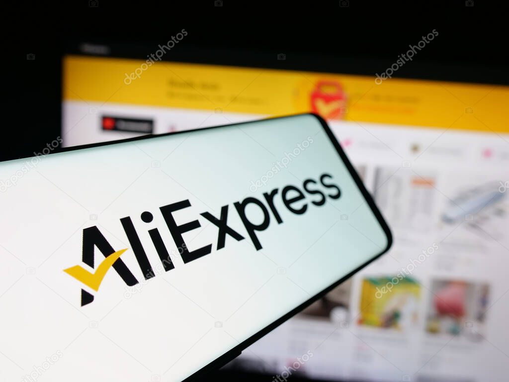 Stuttgart, Germany - 10-01-2025: Smartphone with logo of Chinese e-commerce company AliExpress on screen in front of website. Focus on center-left of phone display.