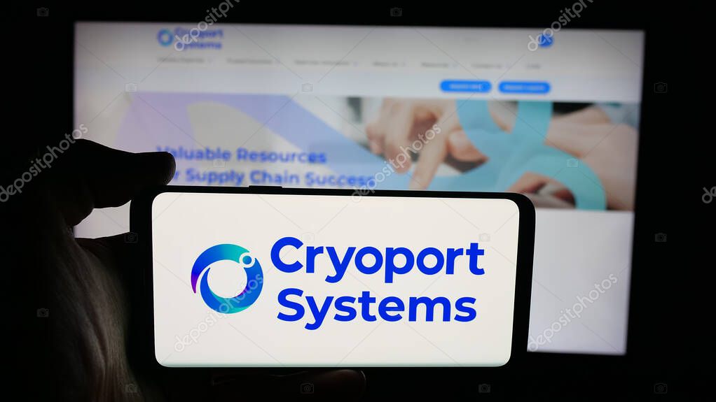 Stuttgart, Germany - 10-04-2025: Person holding cellphone with logo of US supply chain company Cryoport Inc. on screen in front of webpage. Focus on phone display.