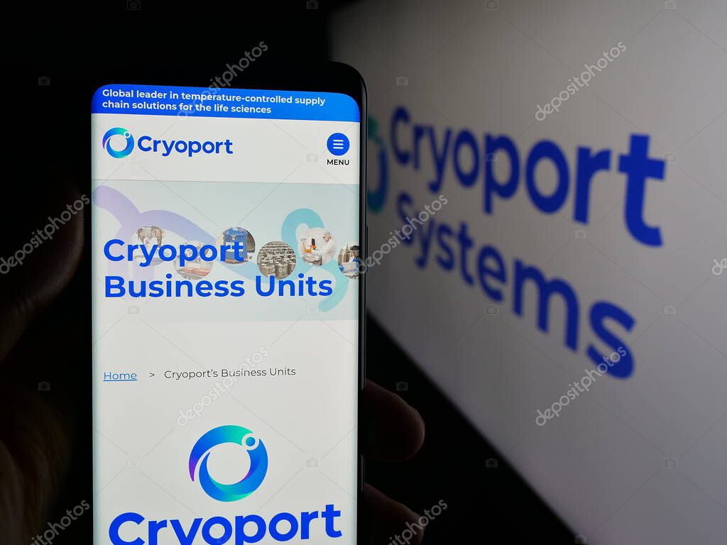 Stuttgart, Germany - 10-04-2025: Person holding cellphone with webpage of US supply chain company Cryoport Inc. on screen in front of logo. Focus on center of phone display.