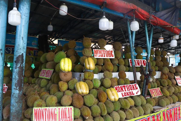 A local shop besides the street selling durians. There are a lot of different types of durians.