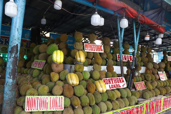 A local shop besides the street selling durians. There are a lot of different types of durians.