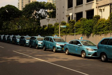 Taxis in Indonesia Waiting in Line to Pick Up Passengers