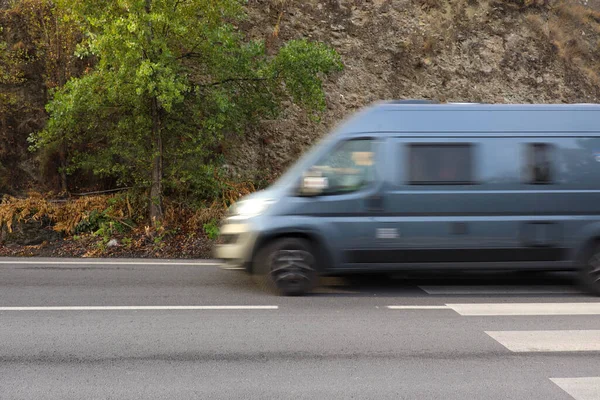 Blue Mini Van High Speed Street Stones Hill Nature Background — стоковое фото