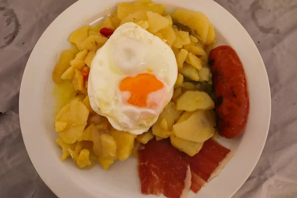 白プレートで提供されるスペインのAlpujarraの典型的な料理であるプラトンAlpujarreo — ストック写真