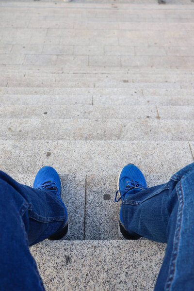 Point of View of a Person Sitting with Blue Jeans and Shoes