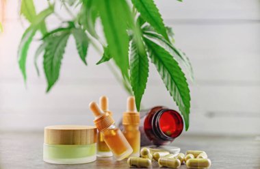 CBD and HHC oil capsules and balm, Medical marijuana products with Cannabis plant clipart
