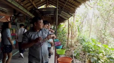 Sapanını geri çeken adam kameranın dışındaki hedefi hedef alıyor. Açık hava aktivitelerinde yetenek ve konsantrasyon sergiliyor.