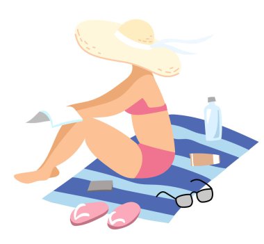 Kadın kumsalda güneşleniyor.