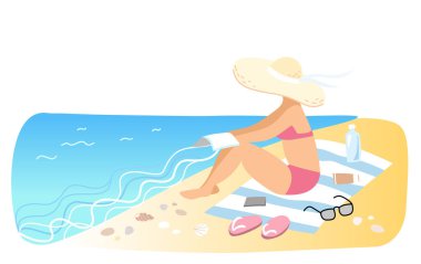 Kadın kumsalda güneşleniyor.