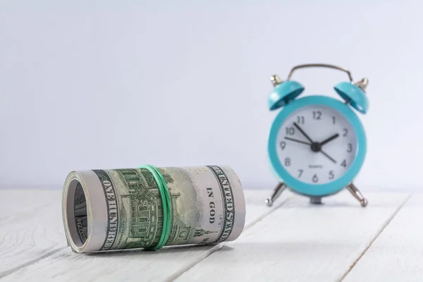 stock image Roll of dollar bills and clock. Time is money concept