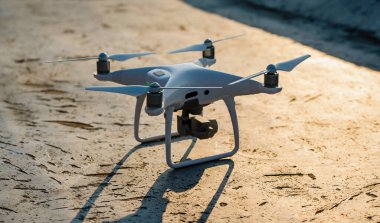 Dışarıdaki dijital kamerayla beyaz drone kuadkopterini kapatın.