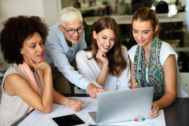 Collaboration and analysis by business people working in office. Successful business women together in corporate office.