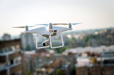 Drone with camera close up on the grey background. Preparation quadrocopter to start flying outdoor.