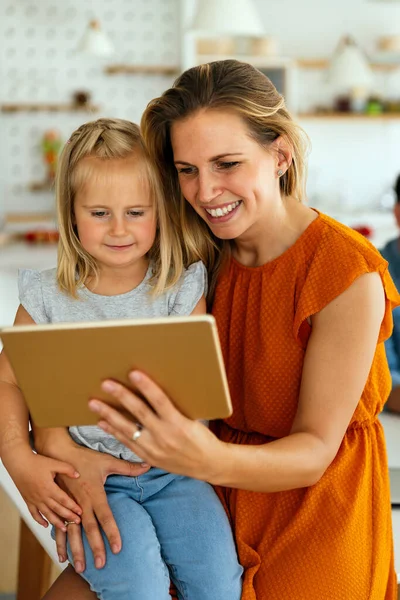Digital device technology family online education concept. Happy young family with digital devices at home.