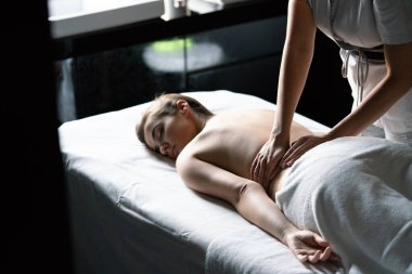 Rahatlatıcı kadın masaj terapisi görüyor.