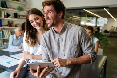Team of multiethnic creative marketing experts brainstorming during working on advertising strategy for company sharing ideas on conference using technology and wireless connection