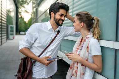 Happy couple in love using digital devises for work, study or social media. People technology concept