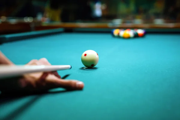 Preparing to break spheres into the pool pocket. People billiard, snooker entertainment fun concept.