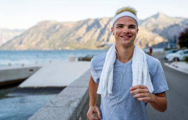 Aktif, formda koşan erkek koşucu sağlıklı kalmak için dışarıda koşuyor. Spor insanları egzersiz konsepti