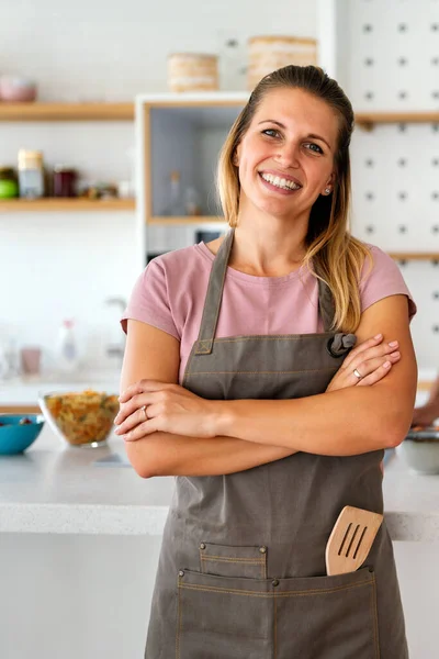 stock image Healthy food at home. Happy woman is preparing organic meal in the kitchen.