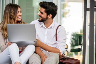 Happy couple in love using digital devises for work, study or social media. People technology concept