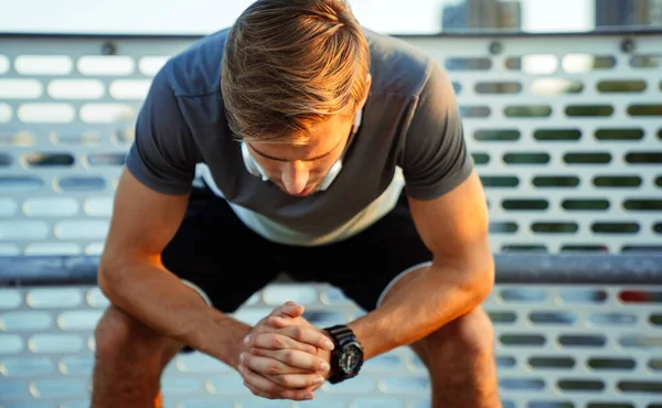 stock image Young fit handsome man take a little break after training outdoor. Fitness sport people lifestyle concept