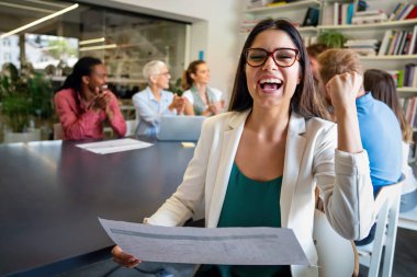 Happy group of multiethnic business people celebrating success at company. Business people work office concept