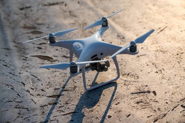 Dışarıdaki dijital kamerayla beyaz drone kuadkopterini kapatın.